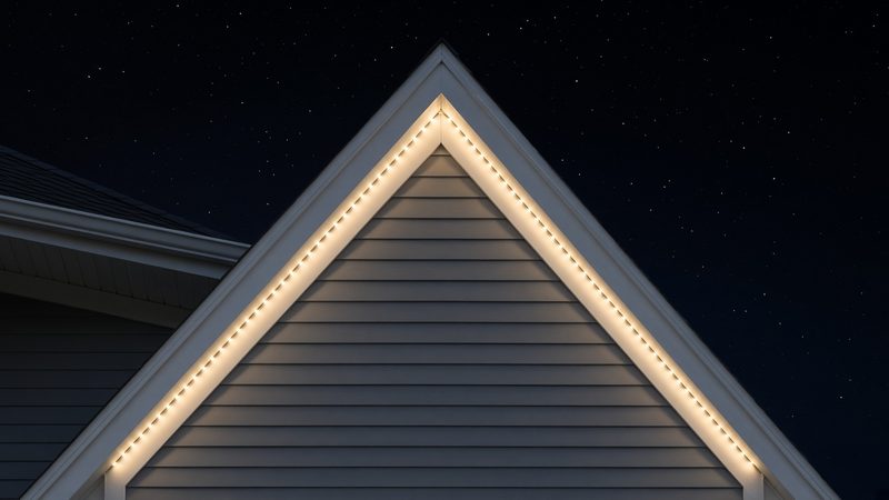 Gable peak at night, with warm white LED points following both roof edges up to the apex